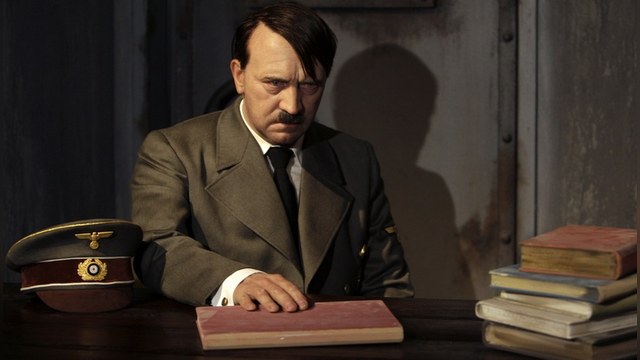 A waxwork of Adolf Hitler before a 41-year-old man tore its head off from the controversial exhibit on the opening day of Berlin's Madame Tussauds July 5, 2008 is seen in this July 3, 2008 file photo. The man was arrested by police after he jumped over the desk and ripped off the head of the waxwork figure in protest of the controversial exhibit that showed a glum-looking Adolf Hitler behind his desk in a mock bunker during the last days of his life.   REUTERS/Tobias Schwarz/Files  (GERMANY) - RTX7NQ0