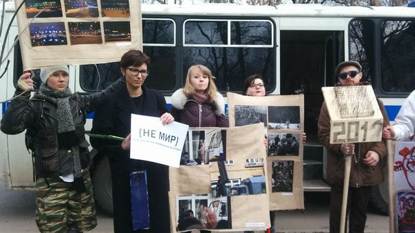 {NE MIR} marchers pose with works before boarding police paddy wagon